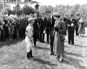 Jockey Gordon Richards is congratulated by Queen Elizabeth II after winning the Epsom