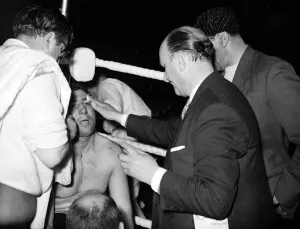 Joe Erskin has the doctor check out his cut eye during his fight with Brian London in