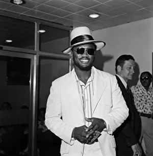 Joe Frazier at Heathrow airport, wearing dark glasses, still covering the injured eye