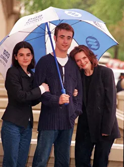 Joe McFadden with Shirley Henderson and Sharon Small standing under BBC umbrella