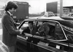 John Carter-Griffiths pays the cabbie Nigel Balcombe for Sammy the Setter