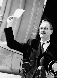 John Cleese Actor in a scene from a comedy show impersonating PM Chamberlain