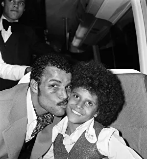 John Conteh celebrates with family aboard a playboy motor coach after winning world title