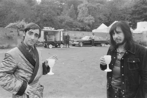 John Entwistle and Keith Moon of the rock group The Who show off their new cars