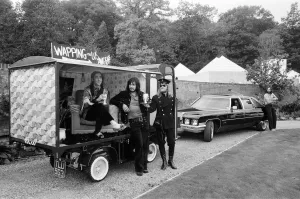 John Entwistle and Keith Moon of the rock group The Who show off their new cars
