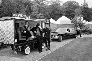 John Entwistle and Keith Moon of the rock group The Who show off their new cars
