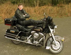 John Gordon Sinclair actor with his feet up on his Harley Davidson Electra Glide