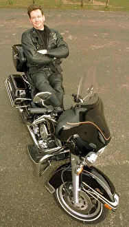 Harley Davidson Prints: John Gordon Sinclair actor leaning back on his Harley Davidson Electra Glide motorcycle