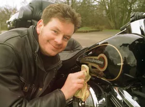 John Gordon Sinclair actor polishing his Harley Davidson Electra Glide motorcycle
