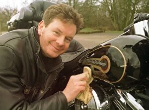 Images Dated 5th March 1997: John Gordon Sinclair polishing his Harley Davidson March 1997