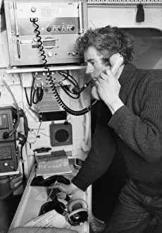 01505 Prints: John Hart receives a message on the ship to shore lifeboat radio in Barry, Wales