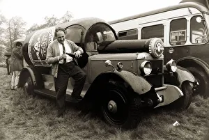 Novelty Vehicle Prints: John Horton from Sussex standing beside a 1924 Daimler built in the shape of a bottle