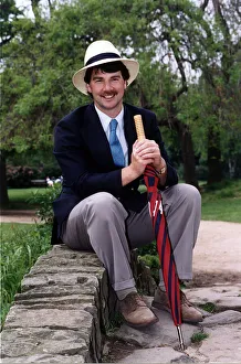 John Kettley TV Weather Forecaster Presenter on BBC TV sitting on small bridge wall