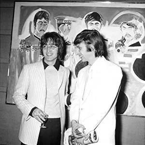 John Lennon with artist Jonathon Hague at an art exhibition at the Royal Institute
