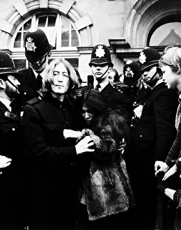 John Lennon Beatles Singer with wife Yoko Ono surrounded by police