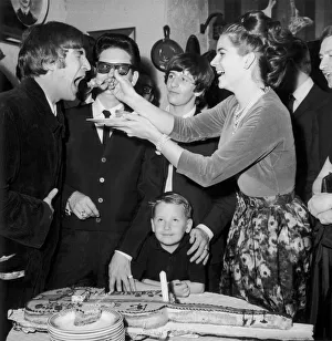 John Lennon being fed birthday cake by Claudette Orbison while her husband Roy