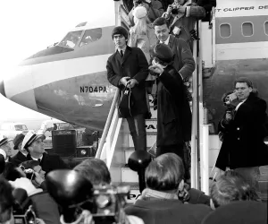 00084 Prints: John Lennon and George Harrison boarding their plane before The Beatles leave for New
