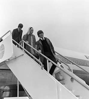 John Lennon and his girlfriend Cynthia 26 May 1964 along with George Harrison get off of