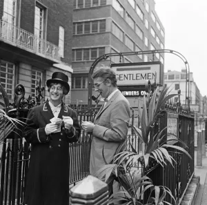 John Lennon (left) plays the part of a club commissionaire in this filming picture