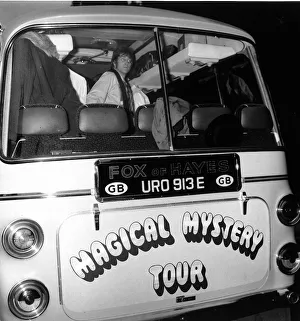 John lennon looks out of the back window of the Magical Mystery Tour Bus as The Beatles