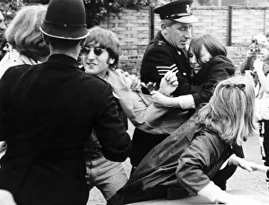 Core08 Prints: John Lennon is mobbed by fans as police try to escort the teenage girls away after