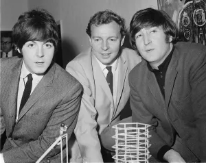 John Lennon and Paul McCartney of The Beatles with producer Johnny Hamp who booked