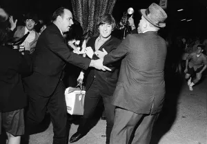 John Lennon and Paul McCartney escaping frenzied reporters at the Forest Hills Tennis