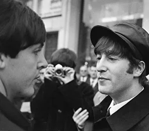 John Lennon and Paul McCartney having their picture taken by George Harrison