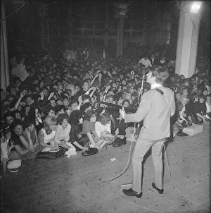 John Lennon performing on stage during the Beatles last British ballroom appearance