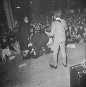 John Lennon performing on stage during the Beatles last British ballroom appearance
