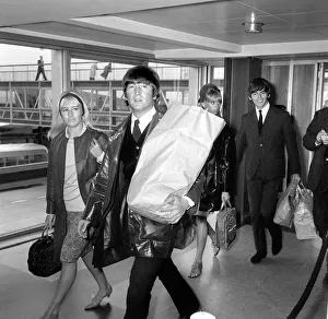 Arriving Prints: John Lennon and his wife Cynthia arrive back at London Airport from their holidays