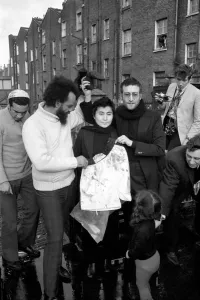 John Lennon and Yoko pictured on the roof of Black House in Holloway Road, with Michael X