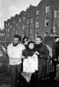 John Lennon and Yoko pictured on the roof of Black House in Holloway Road, with Michael X