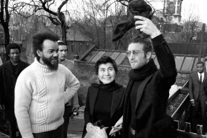 John Lennon and Yoko pictured on the roof of Black House in Holloway Road, with Michael X