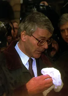 John Major MP wiping his face whilst in Chester after a egg throwing incident diring