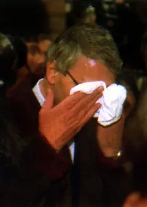 John Major MP wiping his face whilst in Chester after a egg throwing incident diring