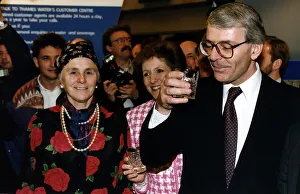 John Major Prime Minister holding a glass of water at the Ideal Home Exhibition in London