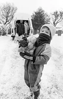 John Martin aged 3, collects supplies from the mobile shop outside his home in Potto