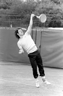John McEnroe, with a foot bandaged and leather support seen here during training running