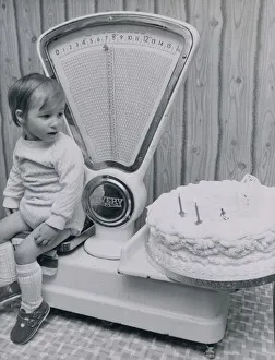 Cakes Prints: John McLean of West Lothian, Scotland checks his weight against his second birthday cake