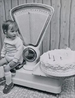 Boys Prints: John McLean of West Lothian, Scotland checks his weight against his second birthday cake