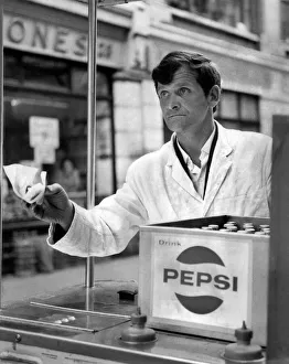 00049 Prints: John O Brien of Londons West End, pushes his hot dog stand from Wardour Mews