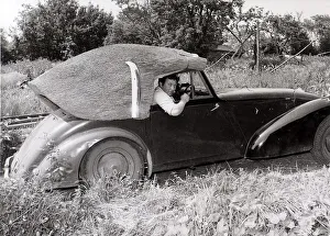 00197 Prints: John Porter, a thatcher by trade, has made a thatched roof for his 1949 Allard which he