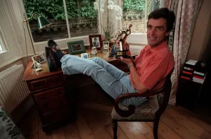John Satpleton TV Presenter September 1998 At home sitting on his desk