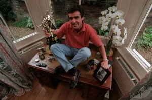 John Stapleton TV Presenter September 1998 At home sitting on his desk