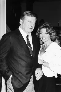 John Wayne with Miss Toni Holt who asked him to do a nude pin-up for her magazine