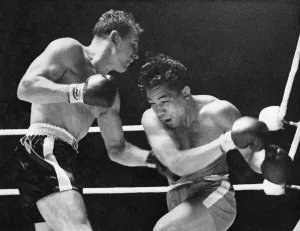 00053 Prints: Johnny Halafihi (Tonga), doubles up as South African Mike Holt slams a left to the body