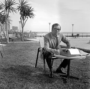 Johnny Speight TV Script Writer - on Spains Costa del Sol sitting at a table