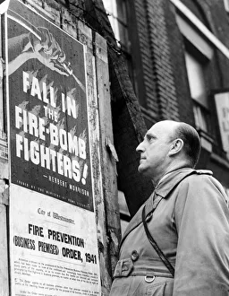 00075 Prints: How to join the firefighters. Man looking at poster encouraging men to recruit