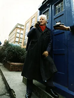 Jon Pertwee actor ex Dr Who leaning against police box like Tardis Glasgow talking